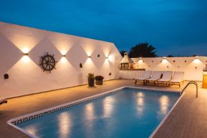 a swimming pool in the middle of a house at Casa Melián in Playa Blanca