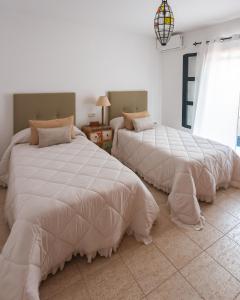 a bedroom with two beds and a window at Casa Melián in Playa Blanca +38 photos