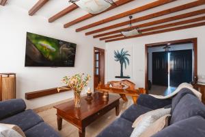 a living room with a blue couch and a table at Casa Melián in Playa Blanca