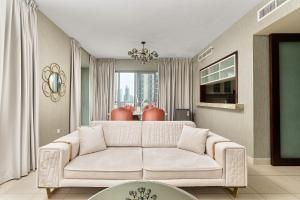 a living room with a white couch and a window at BellaVista Boulevard Central Spacious 2 Bedroom with maids room Burj Khalifa and Fountain View in Dubai