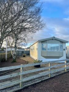 a yellow and white house with a fence at 3 Bedroom Self-Catering Holiday Home in Steps