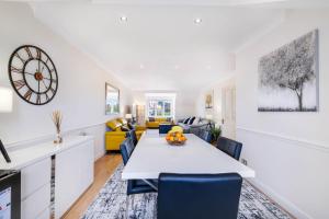 a dining room and living room with a table and chairs at Modern, Bright, Spacious 2 Bed 2 Bath Barnet Penthouse By 360Stays in Barnet
