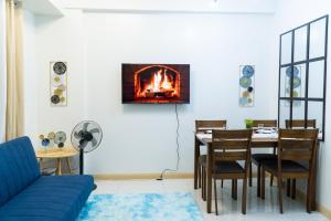 a living room with a table and a fireplace at Condotel Northpoint 2 Bedroom 1 bathroom in Davao City