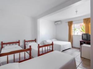 En eller flere senge i et værelse på Pousada Caldas Novas