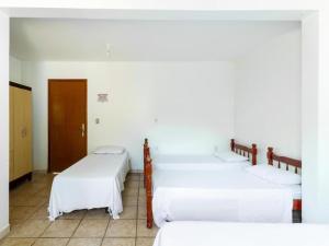 Кровать или кровати в номере Pousada Caldas Novas