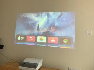 a projection screen on a wall with a video game at Jome Putrajaya Presint 8 Natural Homestay in Putrajaya