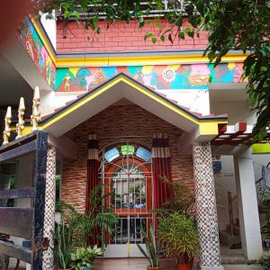 a house with a colorful facade with a window at SHALBITHI HOMESTAy in Bolpur