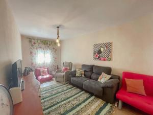 a living room with a couch and a tv at Casa Rural Alboloduy R&R 