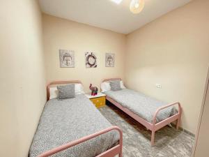 a bedroom with two beds and a night stand at Casa Rural Alboloduy R&R 