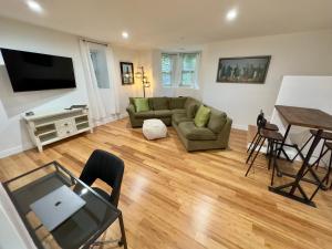 a living room with a couch and a table at Perrin Place Unit 1 in Boston