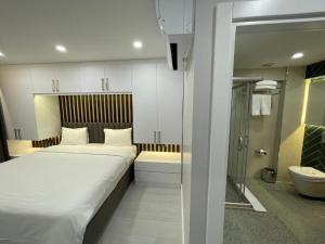 a bedroom with a large bed and a bathroom at Istanbul Apartments in Istanbul