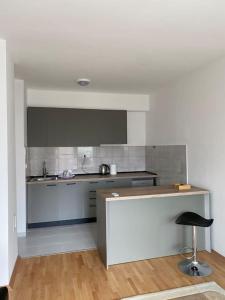 a kitchen with a counter and a stool in a room at Apartment in Skopje in Skopje
