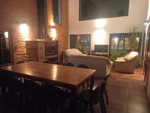 a living room with a wooden table and chairs at La Mexicana - Alta Gracia in Alta Gracia