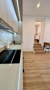 a kitchen with a staircase leading down to a hallway at Casa Branca Apartment in Funchal in Funchal