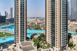 an aerial view of a city with tall buildings at Bellavista - Striking - 1BR with Extra Twin Room - 29 boulevard - Partial Fountain View in Dubai