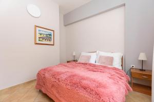 Postel nebo postele na pokoji v ubytování Apartments Ljiljana