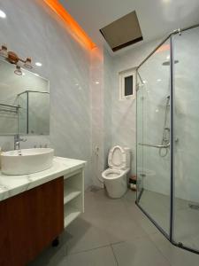 a bathroom with a toilet and a sink and a shower at Da Quy Harmony Homestay in Da Lat