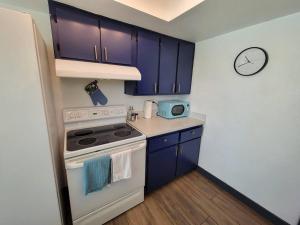 a kitchen with blue cabinets and a white stove top oven at *Msg for 5%off*2Bed1Bath QueenBeds NorthPHX in Phoenix