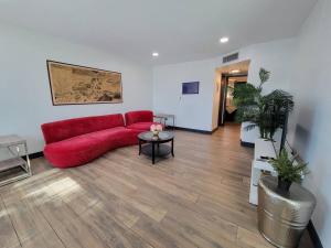 a living room with a red couch and a table at *Msg for 5%off*2Bed1Bath QueenBeds NorthPHX in Phoenix +4 photos