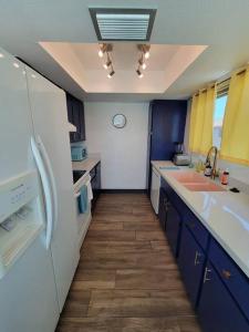 a kitchen with blue cabinets and a white refrigerator at *Msg for 5%off*2Bed1Bath QueenBeds NorthPHX in Phoenix