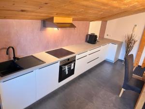 a kitchen with a sink and a stove top oven at Appartement Bichl in Sölden