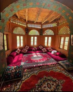 a large room with a large bed with a large rug at Royal Heritage Nagar in Maiūn
