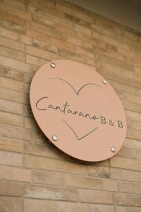a sign with a heart on a brick wall at B & B CANTARANO in Porto Garibaldi