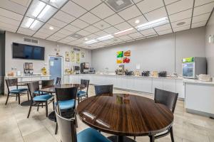 a conference room with tables and chairs and a counter at Quality Inn and Conference Center Tampa-Brandon in Tampa