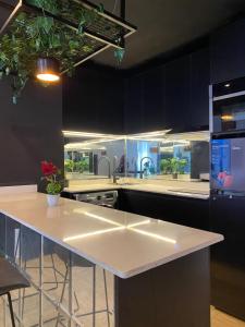 a kitchen with black cabinets and a white counter top at Mos retreat in Lagos