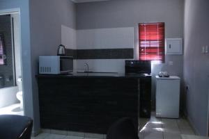 a kitchen with a sink and a counter top at Palapye Guest House in Palatswe