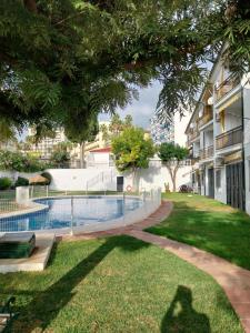 a pool in a yard next to a building at Torremolinos Playa Carihuela in Torremolinos