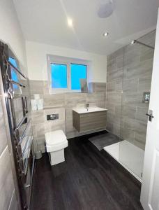 a bathroom with a toilet and a sink and a tub at Entire house - Peaceful 3 bedroom home in Rishton