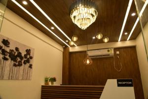 a room with a bench and a chandelier at HOTEL PARK PALACE AND ROOFTOP RESTAURANT in Guwahati