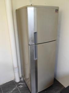 a stainless steel refrigerator sitting in a room at WW Hostel 22A Private Shower in George Town