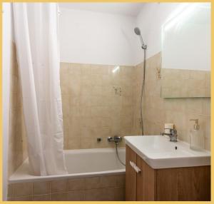 a bathroom with a tub and a sink and a shower at Appartement I Sublime I Les Gets in Les Gets +16 photos