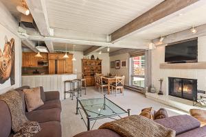 a living room with a couch and a fireplace at Enclave 205, Snowmass Ski-In/Ski-Out Condo w/Shared Pool/Hot Tub/Gym/WiFi in Snowmass Village