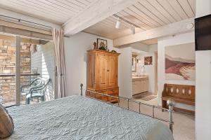 a bedroom with a large bed and a bathroom at Enclave 205, Snowmass Ski-In/Ski-Out Condo w/Shared Pool/Hot Tub/Gym/WiFi in Snowmass Village +21 photos