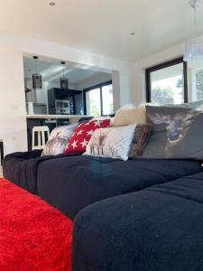 a living room with a couch and a red rug at L'Etoile de la Forêt in Bolquere Pyrenees 2000