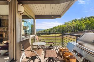 a balcony with chairs and a grill with a view at Enclave 207, Snowmass Ski-In/Ski-Out Condo w/Shared Pool/Hot Tub in Snowmass Village
