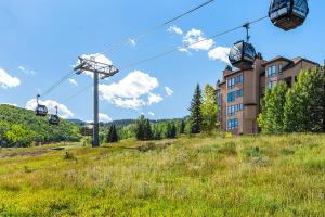 a gondola ride up a hill in a field at Enclave 209, Snowmass Ski-In/Ski-Out Condo w/Shared Pool/Hot Tub in Snowmass Village
