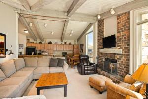 a living room with a couch and a fireplace at Enclave 305, Snowmass Ski-In/Ski-Out Condo w/Shared Pool/Hot Tub in Snowmass Village