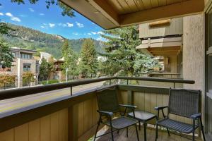 two chairs sitting on a balcony with a view at Concept 600 unit 308, Convenient Downtown Location, Private Deck, and Fireplace in Aspen