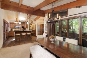 a kitchen and dining room with a wooden table at Little Nell Condominiums Unit 11, Top Floor Condo with Mountain Views, 3 Blocks to Gondola in Aspen