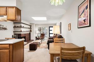 a kitchen and living room with a table and a couch at Timber Ridge Unit 3E in Aspen