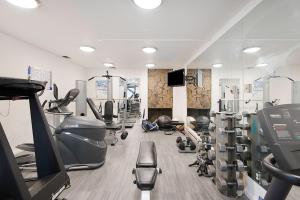 a gym with treadmills and machines in a room at Chateau Eau Claire Unit 1, Stylish Condo Overlooking the River, Walking Distance to Downtown in Aspen
