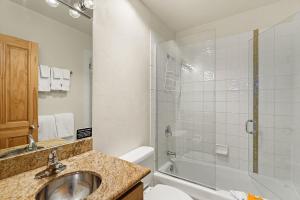 a bathroom with a sink and a shower and a toilet at Chateau Chaumont Unit 19, Spacious Top-Floor Condo with Great Location in Aspen