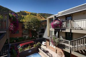 an aerial view of a building with flowers on balconies at Chateau Chaumont Unit 19, Spacious Top-Floor Condo with Great Location in Aspen