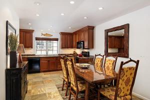 a kitchen with a wooden table and chairs at Alpenblick Unit 18, Spacious Remodeled Townhouse with Great Location in Aspen