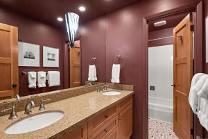 a bathroom with two sinks and a large mirror at Silverglo Condominiums Unit 308, Expansive 4 BD Condo, Walking Distance to Town with Pool Access in Aspen +8 photos