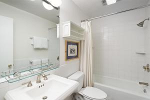 a white bathroom with a sink and a toilet at Alpenblick Unit 18, Spacious Remodeled Townhouse with Great Location in Aspen +13 photos